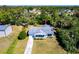 Aerial view of a charming single-story home with a well-manicured lawn and a gray roof at 410 Hinton St, Port Charlotte, FL 33954