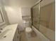 Bathroom showcasing a shower and tub combo with tiled walls and storage at 410 Hinton St, Port Charlotte, FL 33954