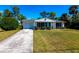 Charming single-story home with a well-manicured lawn, long driveway, and a classic exterior at 410 Hinton St, Port Charlotte, FL 33954