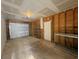 Unfinished garage with wood stud walls and a white metal garage door and open ceiling at 410 Hinton St, Port Charlotte, FL 33954