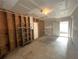 Unfinished garage with wood stud walls and a white metal door and open ceiling at 410 Hinton St, Port Charlotte, FL 33954