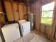 Laundry room with washer, dryer, and water heater in an unfinished space at 410 Hinton St, Port Charlotte, FL 33954