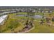 Picturesque aerial view of the community golf course with mature trees and lush landscaping at 437 Cerromar Ln # 418, Venice, FL 34293