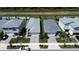 Aerial view of several homes with manicured lawns and driveways, showcasing the neighborhood's layout and design at 43735 Cattleman Dr, Punta Gorda, FL 33982