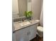 Modern bathroom features a granite countertop vanity, sink, and coordinating toilet at 43735 Cattleman Dr, Punta Gorda, FL 33982