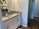 Bathroom features a dual sink vanity with a granite countertop and tile floors at 43735 Cattleman Dr, Punta Gorda, FL 33982