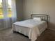 Cozy bedroom with plush carpeting and natural light through sheer curtains at 43735 Cattleman Dr, Punta Gorda, FL 33982