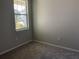 Bedroom with neutral paint, plush carpet, and a bright window offering natural light at 43735 Cattleman Dr, Punta Gorda, FL 33982