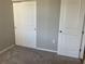 Cozy bedroom featuring neutral paint, plush carpet, and a closet with sliding doors at 43735 Cattleman Dr, Punta Gorda, FL 33982