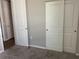 Bedroom featuring plush carpet, neutral paint, and multiple doorways to other rooms at 43735 Cattleman Dr, Punta Gorda, FL 33982