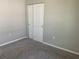 Cozy bedroom featuring neutral paint, plush carpet, and a closet with sliding doors at 43735 Cattleman Dr, Punta Gorda, FL 33982
