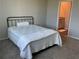 Bedroom features neutral paint, plush carpeting, and a doorway to the bathroom at 43735 Cattleman Dr, Punta Gorda, FL 33982