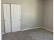 Cozy bedroom featuring neutral paint, plush carpet, and a closet with sliding doors at 43735 Cattleman Dr, Punta Gorda, FL 33982