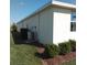 Exterior view showing a well manicured lawn, AC unit, and landscaping with pine straw at 43735 Cattleman Dr, Punta Gorda, FL 33982