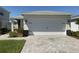 Well-maintained home featuring a spacious two-car garage with an attractive stone-accented facade at 43735 Cattleman Dr, Punta Gorda, FL 33982