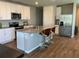 Stylish kitchen featuring white cabinetry, stainless steel appliances, and a center island with seating at 43735 Cattleman Dr, Punta Gorda, FL 33982