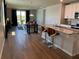 Open-concept living space with wood floors, a modern kitchen, and a view of the outdoor scenery at 43735 Cattleman Dr, Punta Gorda, FL 33982