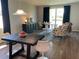 Bright living room features sliding glass doors, dark wood floors and modern furniture at 43735 Cattleman Dr, Punta Gorda, FL 33982