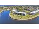 Wide aerial shot of waterfront condos with lush landscaping, surrounded by canals and residential homes at 601 Shreve St # 36C, Punta Gorda, FL 33950