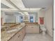Bathroom featuring granite countertops, mirrored wall, and ample lighting at 601 Shreve St # 36C, Punta Gorda, FL 33950
