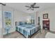 Cozy bedroom features ample natural light, hardwood floors and a ceiling fan at 601 Shreve St # 36C, Punta Gorda, FL 33950