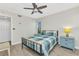 Cozy bedroom with a ceiling fan, light wood floors, and a window bringing in plenty of natural light at 601 Shreve St # 36C, Punta Gorda, FL 33950