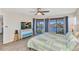 Bedroom with water view, access to balcony and a colorful dresser with TV at 601 Shreve St # 36C, Punta Gorda, FL 33950