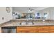Granite countertops accent the stainless steel sink and wooden cabinets in this open floorplan kitchen at 601 Shreve St # 36C, Punta Gorda, FL 33950