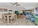 Spacious living room and dining area with ceiling fans, modern decor, and sliding glass doors to the balcony at 601 Shreve St # 36C, Punta Gorda, FL 33950