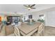 Open floor plan blends dining and living spaces with ceiling fans and access to balcony through sliding glass doors at 601 Shreve St # 36C, Punta Gorda, FL 33950