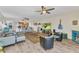Open-concept living space featuring a large TV, modern furniture, and a dining area with seating at 601 Shreve St # 36C, Punta Gorda, FL 33950