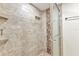 Tiled shower with a glass door, built-in shelves and showerhead with handheld attachment at 601 Shreve St # 36C, Punta Gorda, FL 33950
