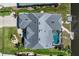 Aerial view of a home with a screened-in pool, lush lawn, and waterfront access at 609 Macedonia Dr, Punta Gorda, FL 33950