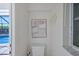 Small bathroom featuring a toilet, vanity, and beach themed artwork at 609 Macedonia Dr, Punta Gorda, FL 33950