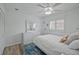 Airy bedroom with hardwood floors, ceiling fan, and white furniture at 609 Macedonia Dr, Punta Gorda, FL 33950