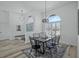Dining area showcasing modern lighting, wood floors, and an open design leading to other living spaces at 609 Macedonia Dr, Punta Gorda, FL 33950