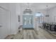Stylish foyer with gorgeous front doors, wood floors, and a modern chandelier at 609 Macedonia Dr, Punta Gorda, FL 33950