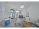 Bright living room featuring a blue front door, modern lighting, and an open floor plan to the dining area at 609 Macedonia Dr, Punta Gorda, FL 33950