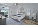 Serene primary bedroom with a ceiling fan, modern decor, and sliding door access to the outdoor area at 609 Macedonia Dr, Punta Gorda, FL 33950