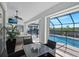 Enclosed patio seating area featuring a glass table, stylish chairs, and picturesque pool views at 609 Macedonia Dr, Punta Gorda, FL 33950