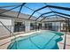 Backyard pool area featuring an enclosed pool, patio, and scenic views of the surrounding greenery at 609 Macedonia Dr, Punta Gorda, FL 33950