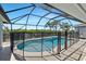 Enclosed pool with a safety fence, offering privacy and protection, perfect for Gathering enjoyment at 609 Macedonia Dr, Punta Gorda, FL 33950
