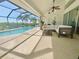 Covered pool area featuring an outdoor seating area and scenic views of the backyard and the water at 609 Macedonia Dr, Punta Gorda, FL 33950