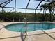 Sparkling screened-in pool with a view of the lush mangroves and canal at 609 Macedonia Dr, Punta Gorda, FL 33950