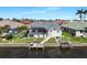 Back of home featuring pool, screened-in lanai, waterfront, and boat dock at 609 Macedonia Dr, Punta Gorda, FL 33950