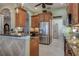 Stylish kitchen featuring stainless steel refrigerator and elegant stone countertops at 8899 Eagle Bay Ct, North Port, FL 34287