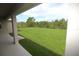 Expansive backyard view from the covered lanai, showcasing lush green grass and natural landscaping at 9529 Calumet Blvd, Port Charlotte, FL 33981