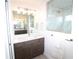 Modern bathroom with dark wood vanity, quartz countertops, and a large framed mirror, designed with great taste at 9529 Calumet Blvd, Port Charlotte, FL 33981
