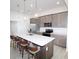 Spacious kitchen island with barstool seating and modern pendant lights, perfect for entertaining guests at 9529 Calumet Blvd, Port Charlotte, FL 33981