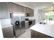 Modern kitchen with stainless steel appliances, stylish cabinets, granite countertops, and tile backsplash at 9529 Calumet Blvd, Port Charlotte, FL 33981